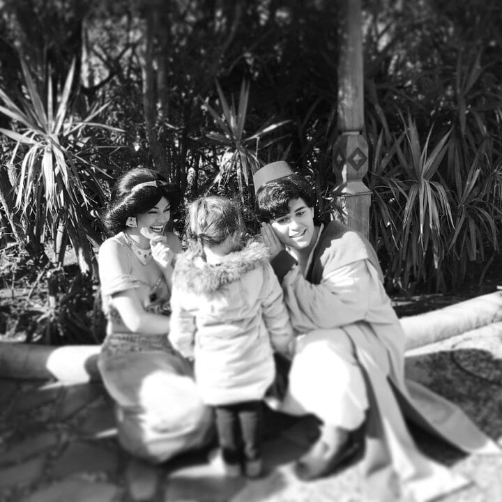 little girl meeting a laughing Aladdin and Jasmine at Tokyo Disneysea