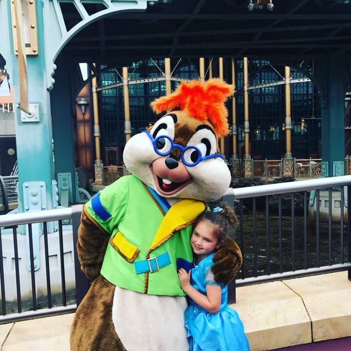 little girl smiling next to Chip and Dale at Tokyo Disneysea