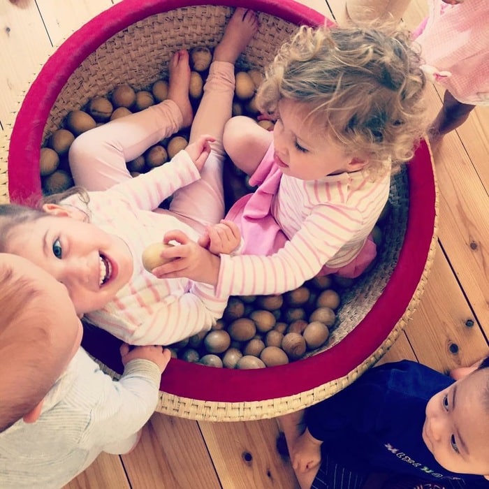 Children playing in wooden ball pit at Tokyo Toy Museum