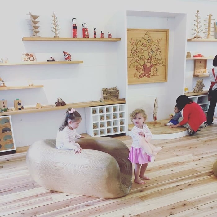 Children playing in minimalist Toy Museum in Tokyo